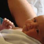 newborn baby wrapped in hospital blanket