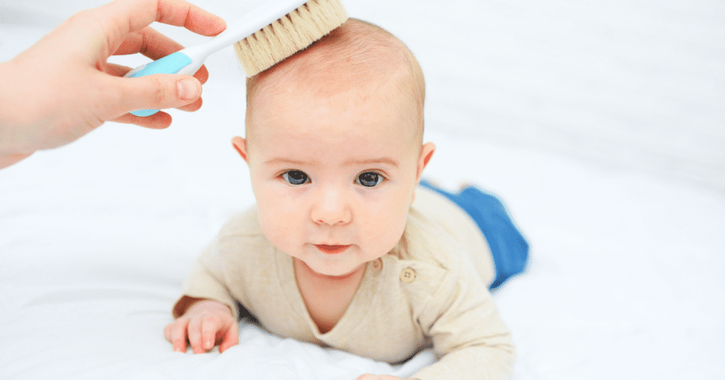 brushing baby hair with soft brush cradle cap