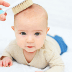 brushing baby hair with soft brush cradle cap