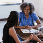 Choosing an OB/GYN or Midwife, a care provider sits with a family