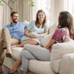 Birth Doulas Meeting with a Pregnant Couple sitting on a couch