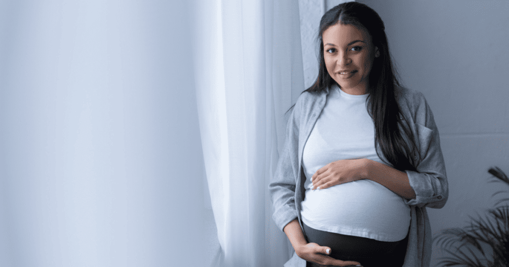 Pregnant Mother holds belly, Braxton Hicks Contractions