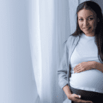 Pregnant Mother holds belly, Braxton Hicks Contractions