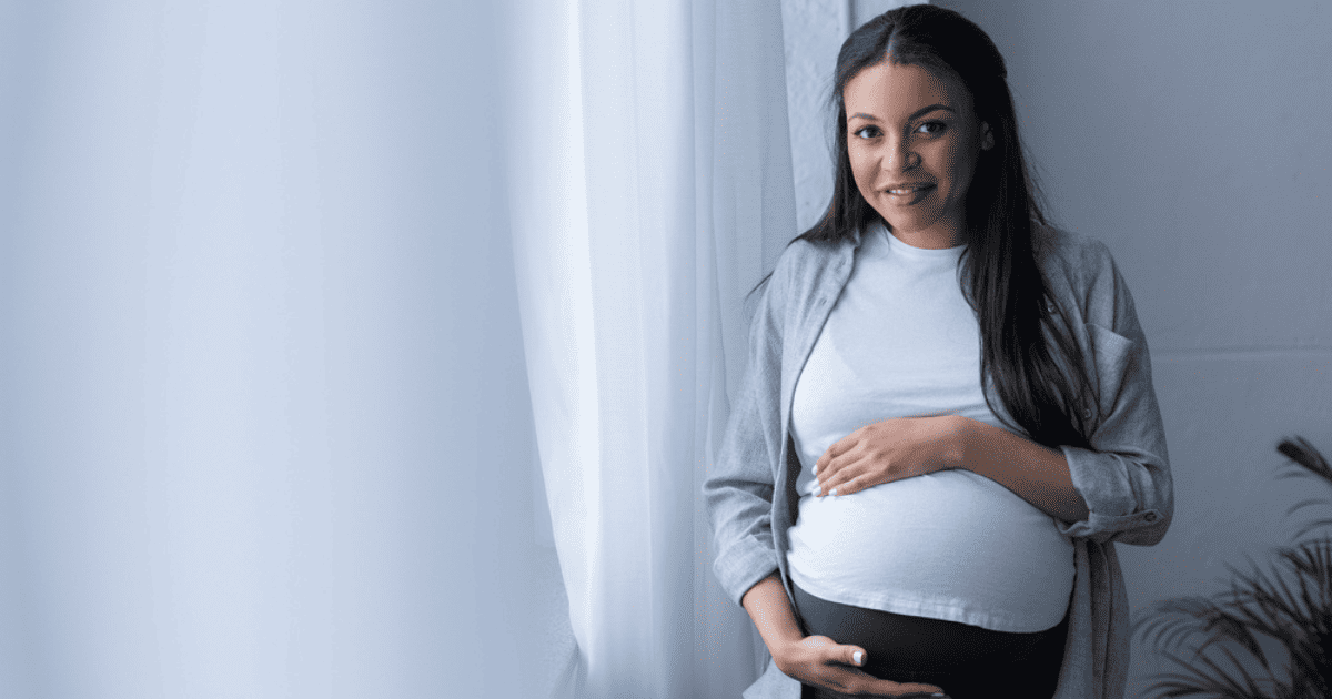 Pregnant Mother holds belly, Braxton Hicks Contractions