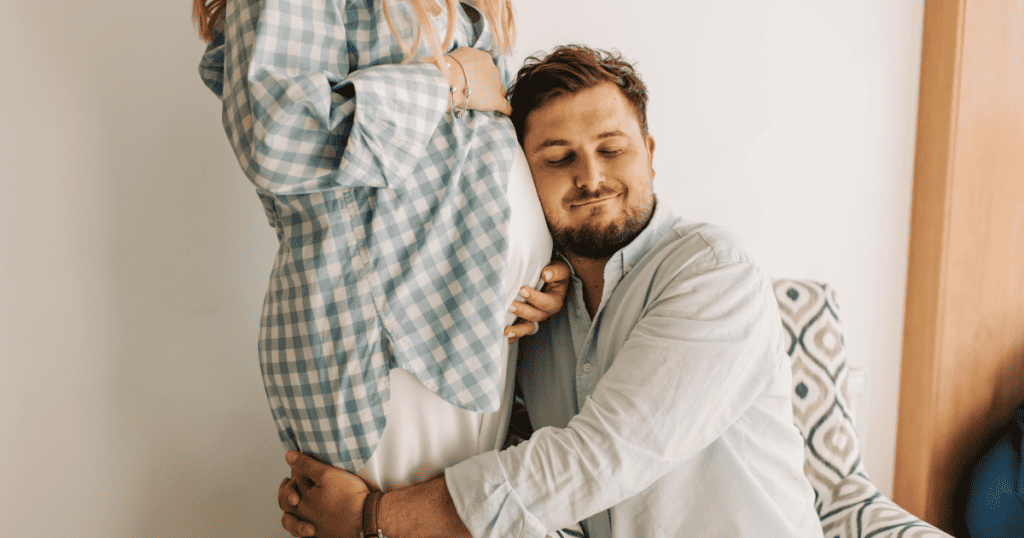 Pregnancy After 35, Advanced Maternal Age, man hugging pregnant woman