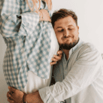 Pregnancy After 35, Advanced Maternal Age, man hugging pregnant woman
