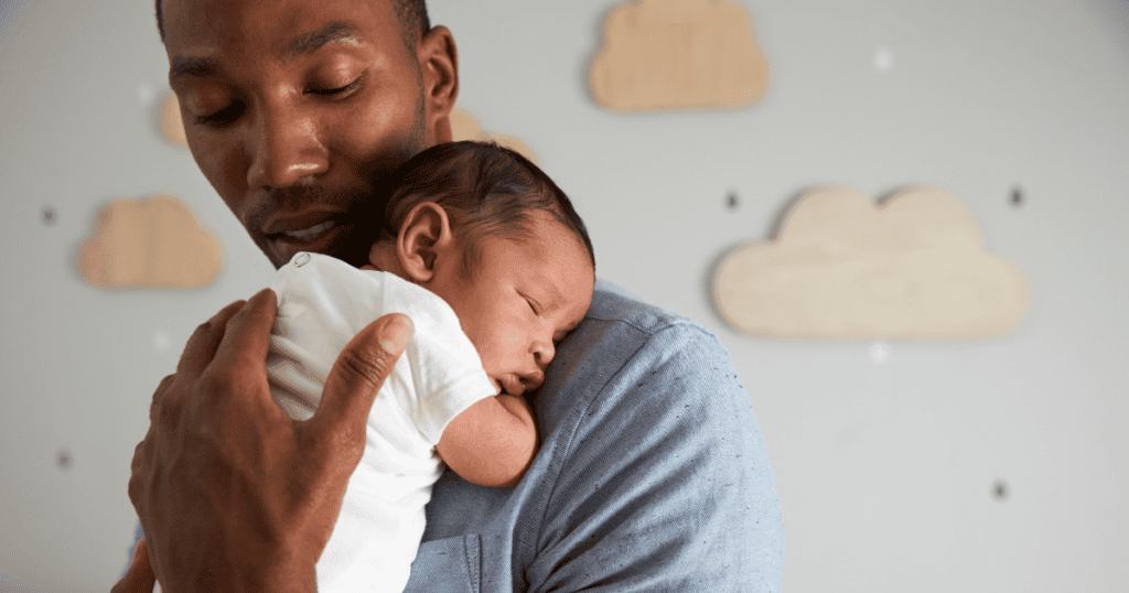 Dad holding newborn baby sleeping, baby sleep stages