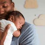 Dad holding newborn baby sleeping, baby sleep stages