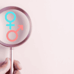 Gender disappointment, magnifying glass looking at boy or girl symbol