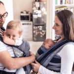 Two parents wearing their babies, babywearing guide