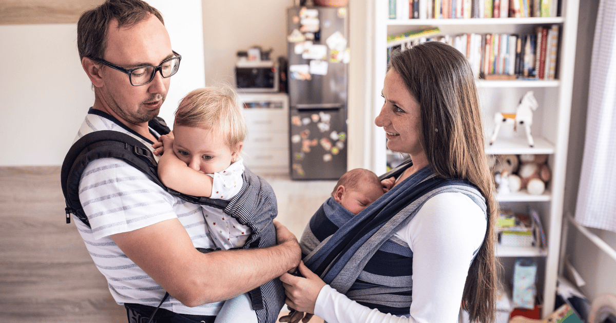 Two parents wearing their babies, babywearing guide