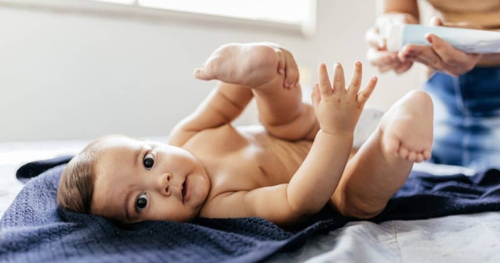 diaper rash treatment, mom putting ointment on baby bottom