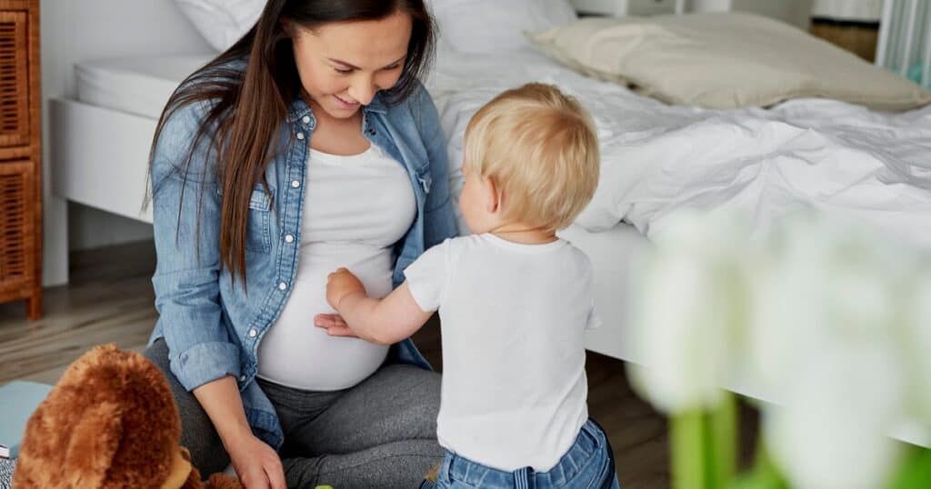 pregnant mom and toddler touching her belly, baby movement, fetal kick counting