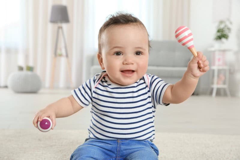 Baby holding a rattle, baby music class