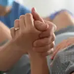 labor support in delivery room, couple holding hands