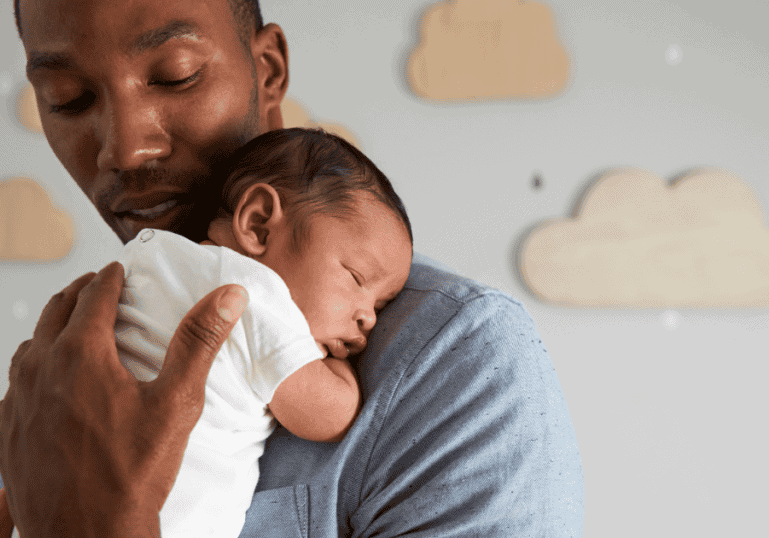 Dad holding newborn baby sleeping, baby sleep stages