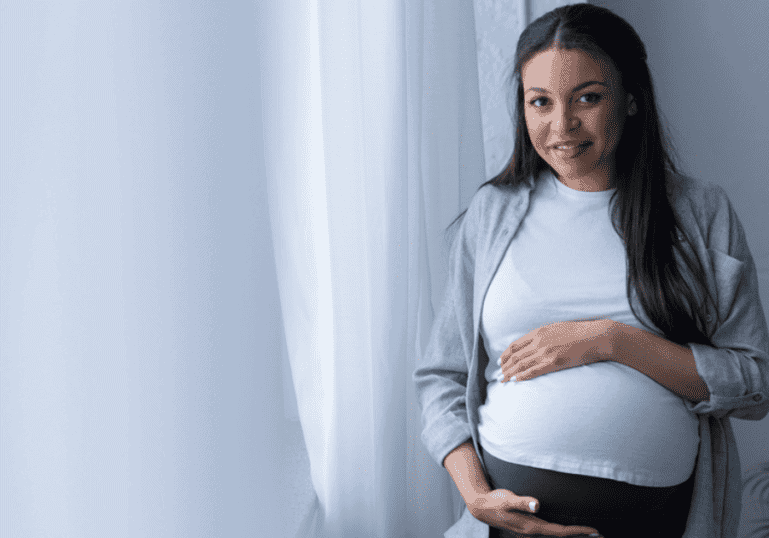 Pregnant Mother holds belly, Braxton Hicks Contractions