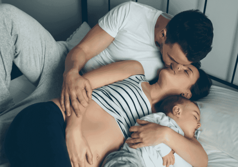 Intimate Connection With Partner, Mom and Dad kissing, baby lying next to them