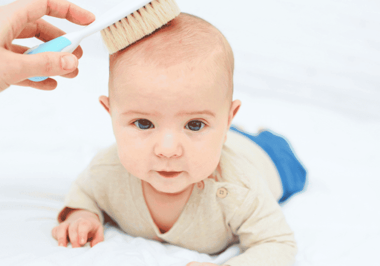 brushing baby hair with soft brush cradle cap