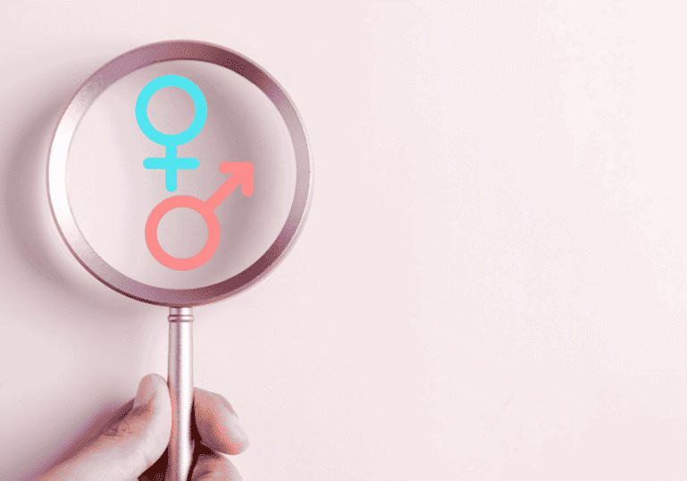 Gender disappointment, magnifying glass looking at boy or girl symbol