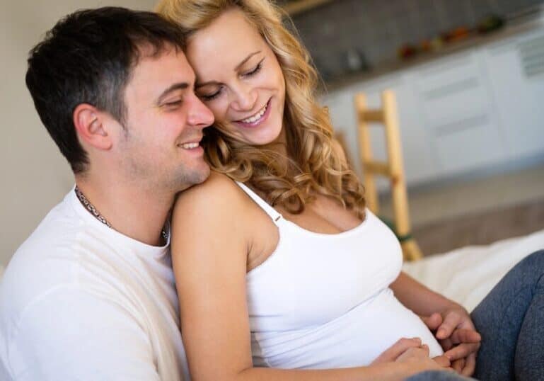 Pregnant Mom and husband snuggling, how sex and help induce labor