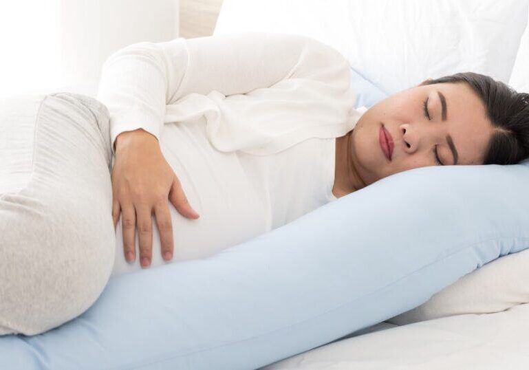 Pregnant Mom lying in bed, PCOS and Pregnancy