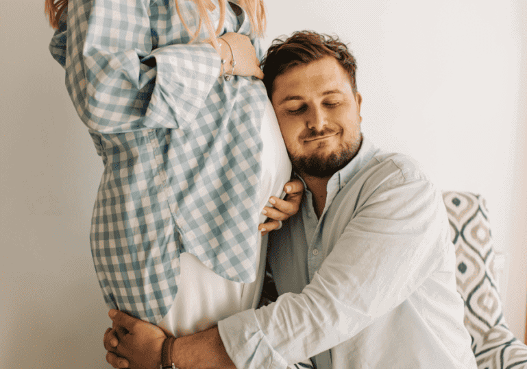 Pregnancy After 35, Advanced Maternal Age, man hugging pregnant woman
