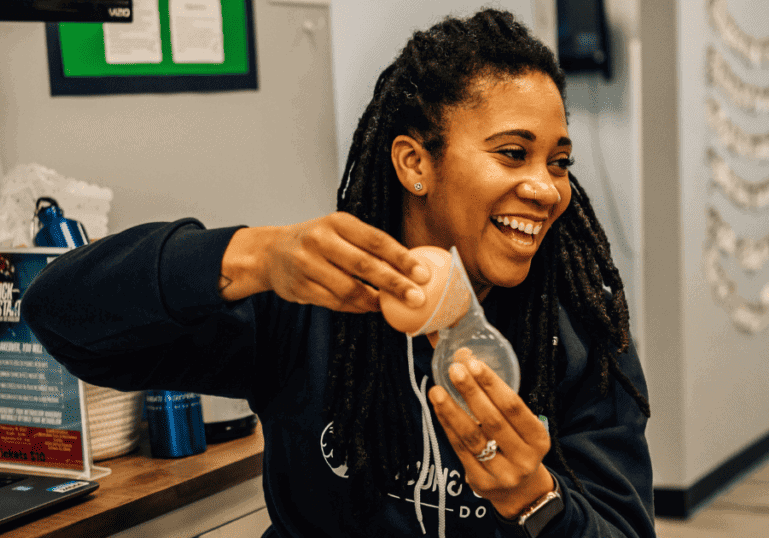 Breastfeeding Class Instructor showing how to use a haakaa breast pump