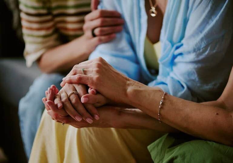 comforting hands supporting each other at a support group