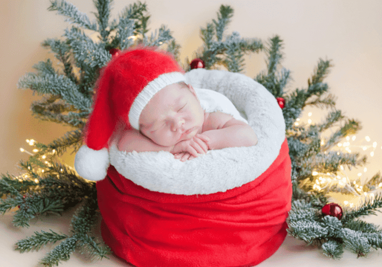 Surviving the holidays with a newborn, newborn baby in a Santa hat