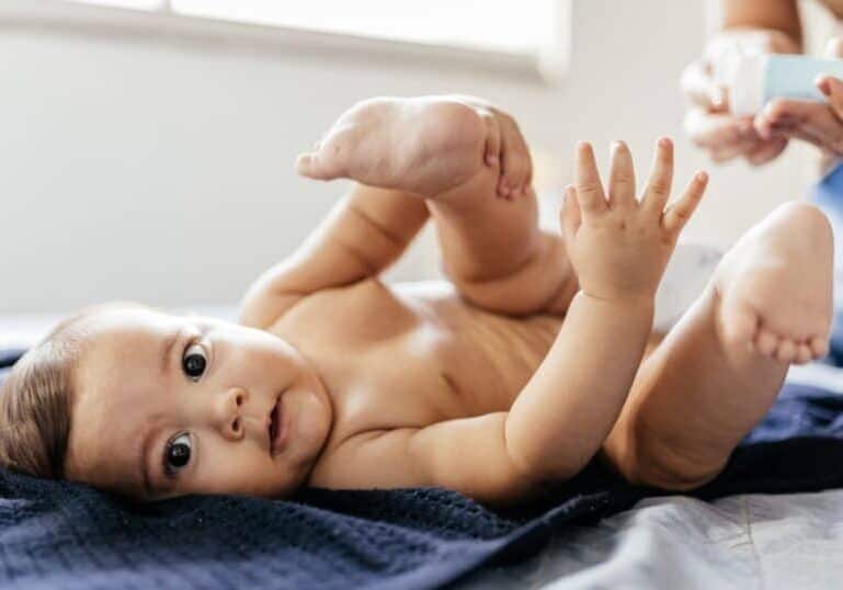 diaper rash treatment, mom putting ointment on baby bottom