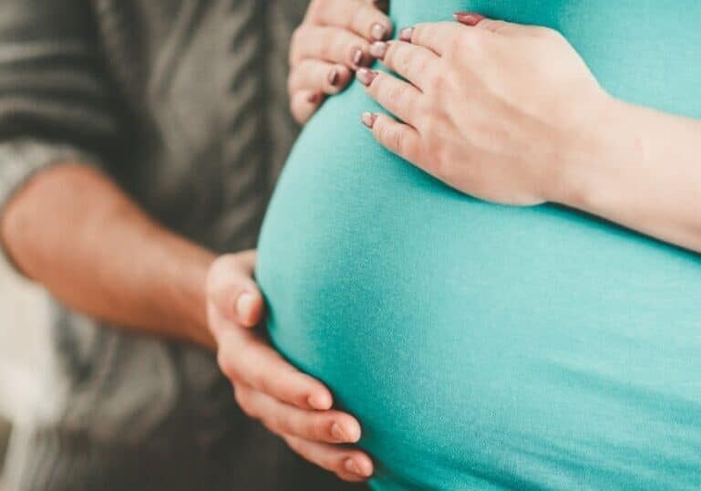 maternal bonding, hands on pregnant belly